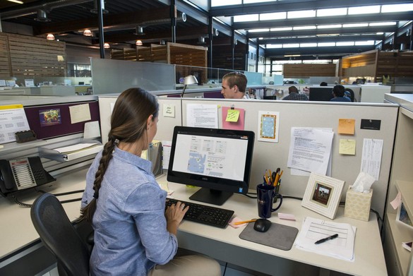 Woman Seated at Desk Using OptiPlex 3030 AIO Touch Desktop