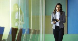 Businesswoman in Hallway Using Venue 8 Pro Tablet