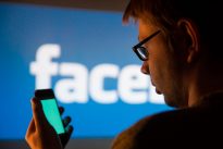 Man using Facebook application on smartphone